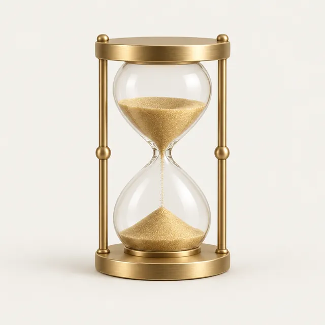 An hourglass filled with gold sand